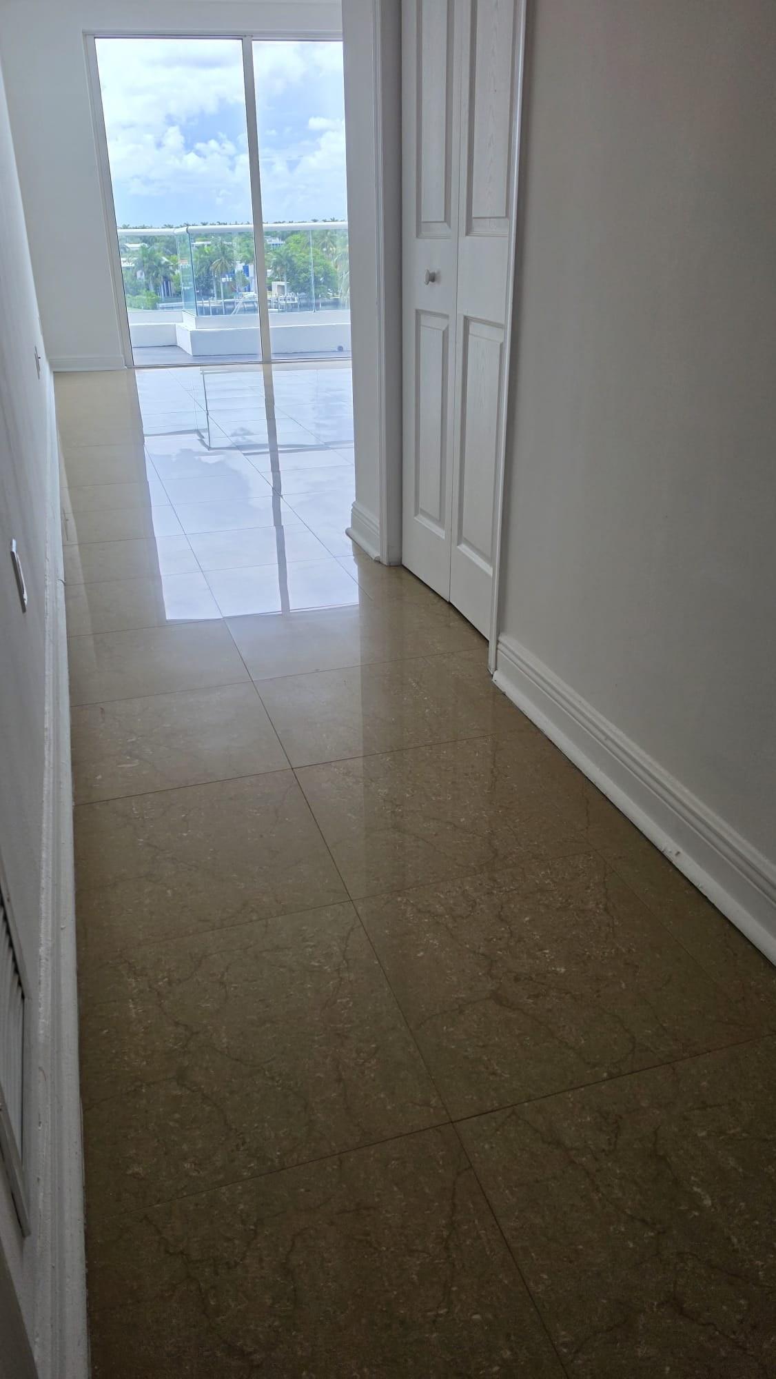 Marble floor in a Miami Beach high-rise condo hallway after stone restoration