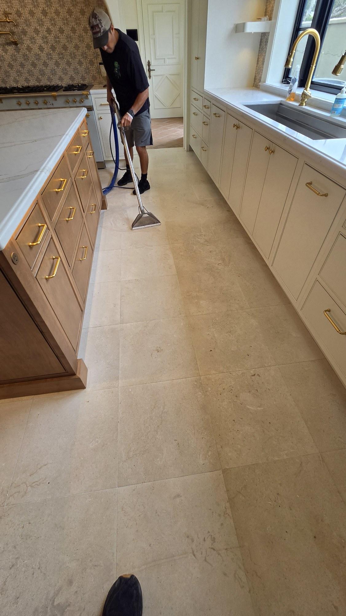 Shellstone Haze Removal in Miami Beach, Low Moisture Extraction Technician removing construction haze from a shellstone kitchen floor in Miami Beach using a low moisture extraction wand