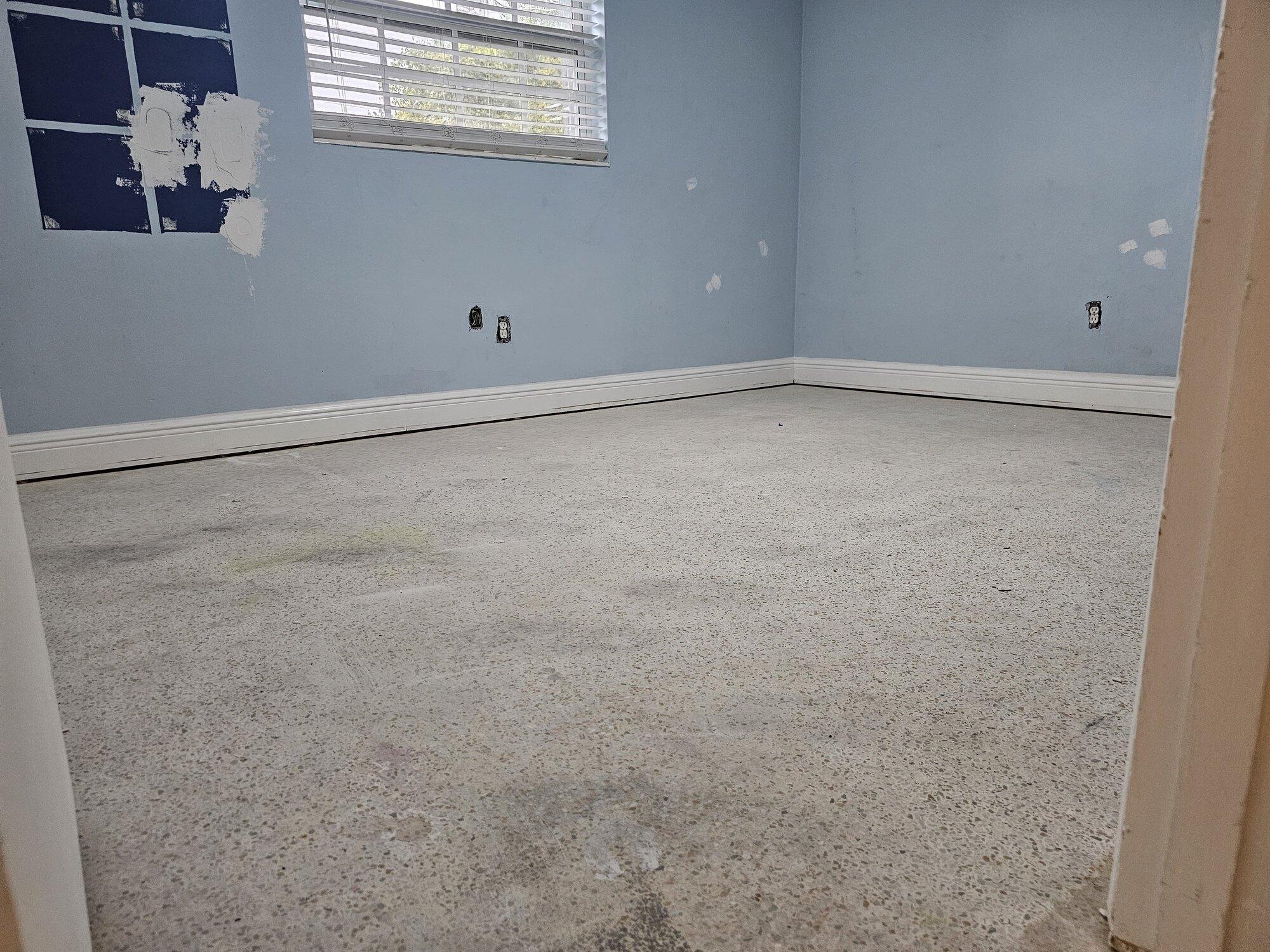 Original terrazzo floor in Westchester Miami before grinding, stained and dull