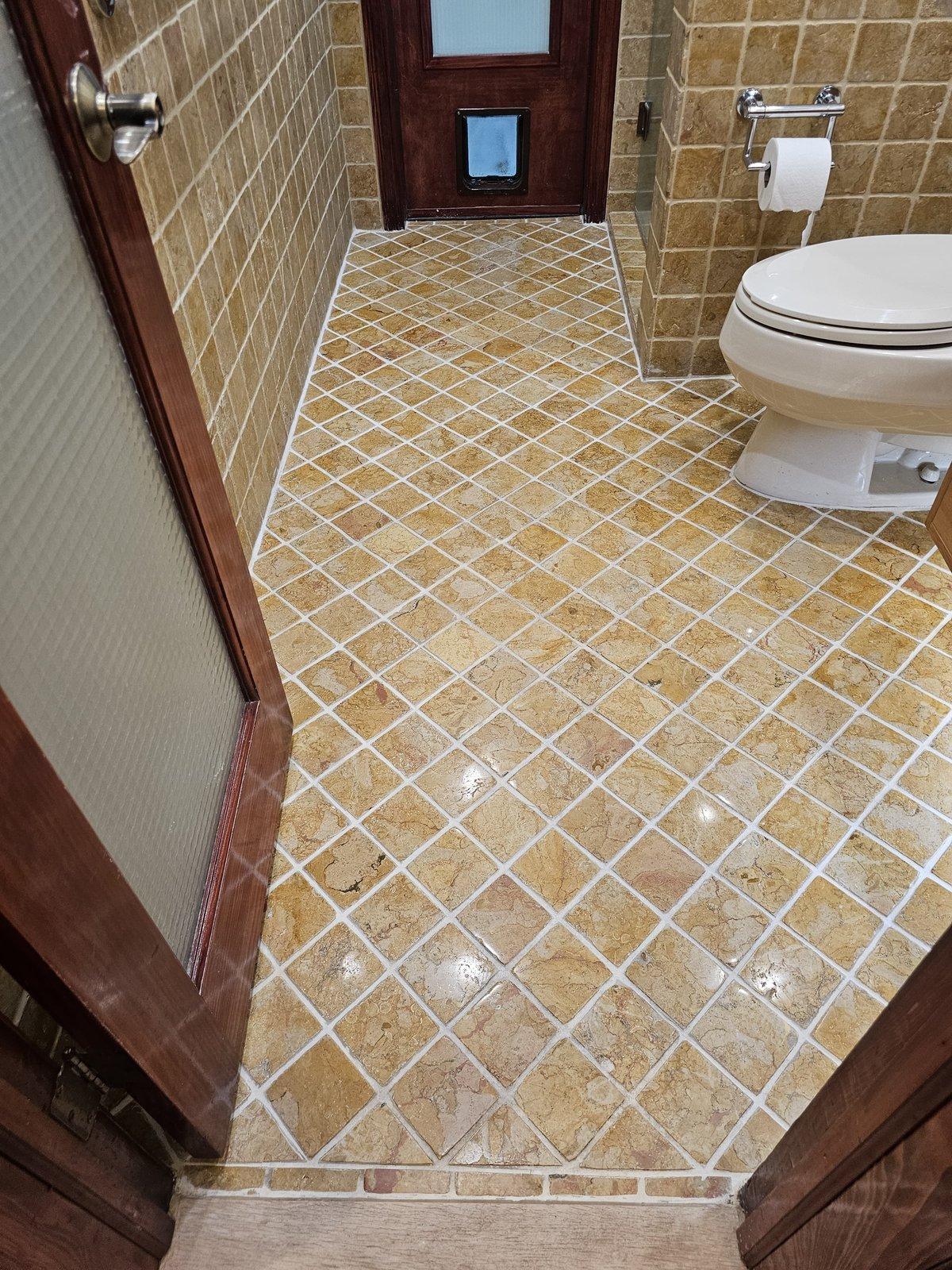 Tumbled travertine bathroom floor in Kendall after stripping, polishing and sealing