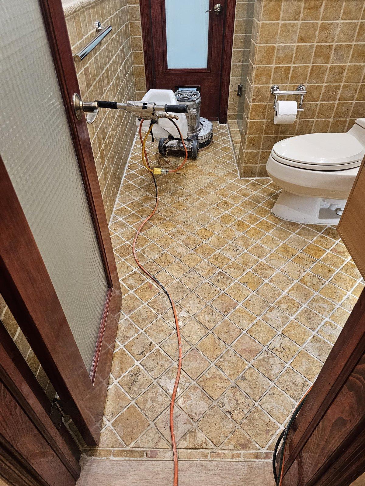Stripping a failed acrylic sealer from a tumbled travertine bathroom floor in Kendall