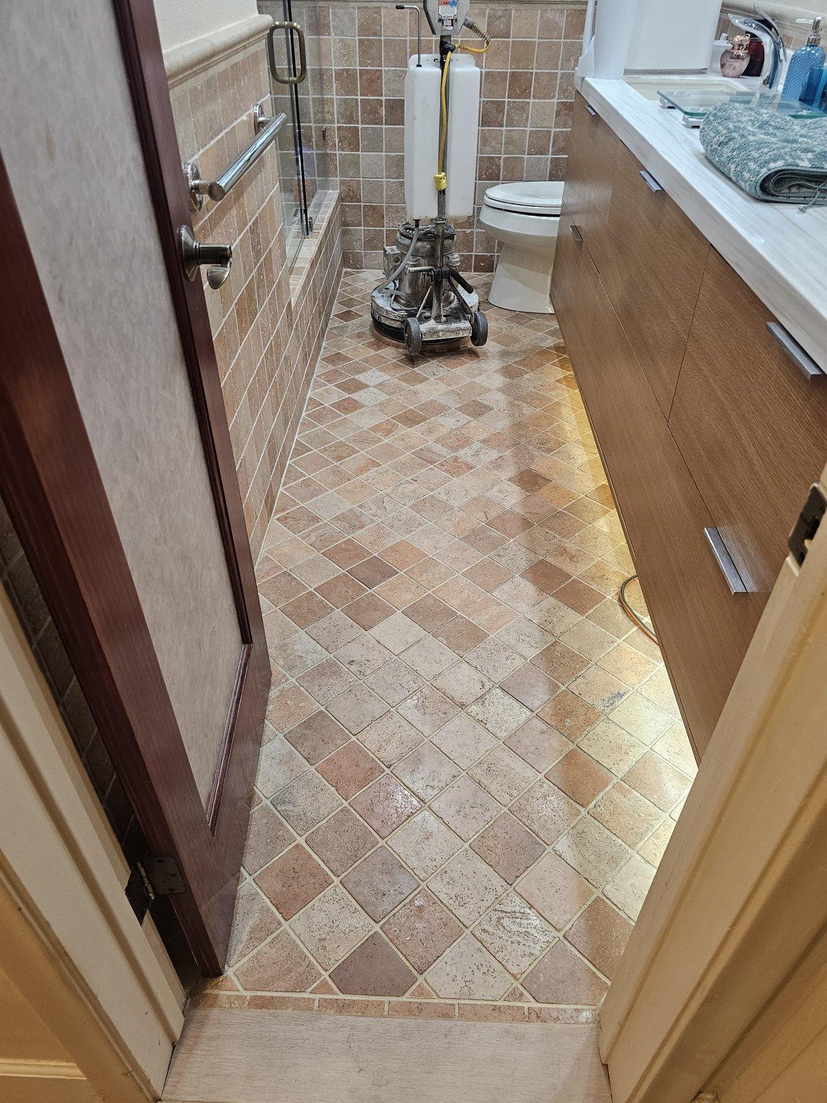 Tumbled travertine bathroom floor in Kendall during acrylic sealer removal
