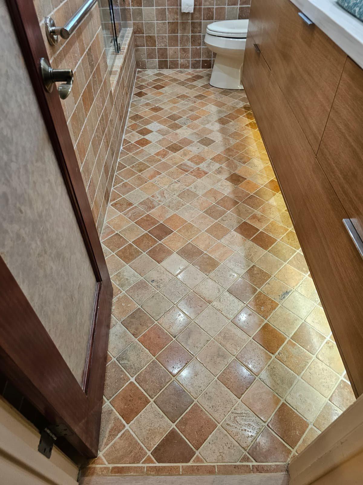 Cleaned, polished and sealed tumbled travertine floor in a Kendall bathroom