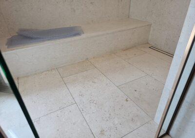 Shellstone shower floor and built-in bench in Miami Beach after deep cleaning, an anti-slip treatment and a penetrating impregnator sealer