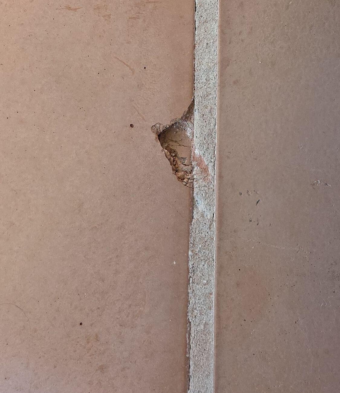 Chipped original terracotta tile, Miami Beach Chipped edge of an original terracotta floor tile in a Miami Beach home