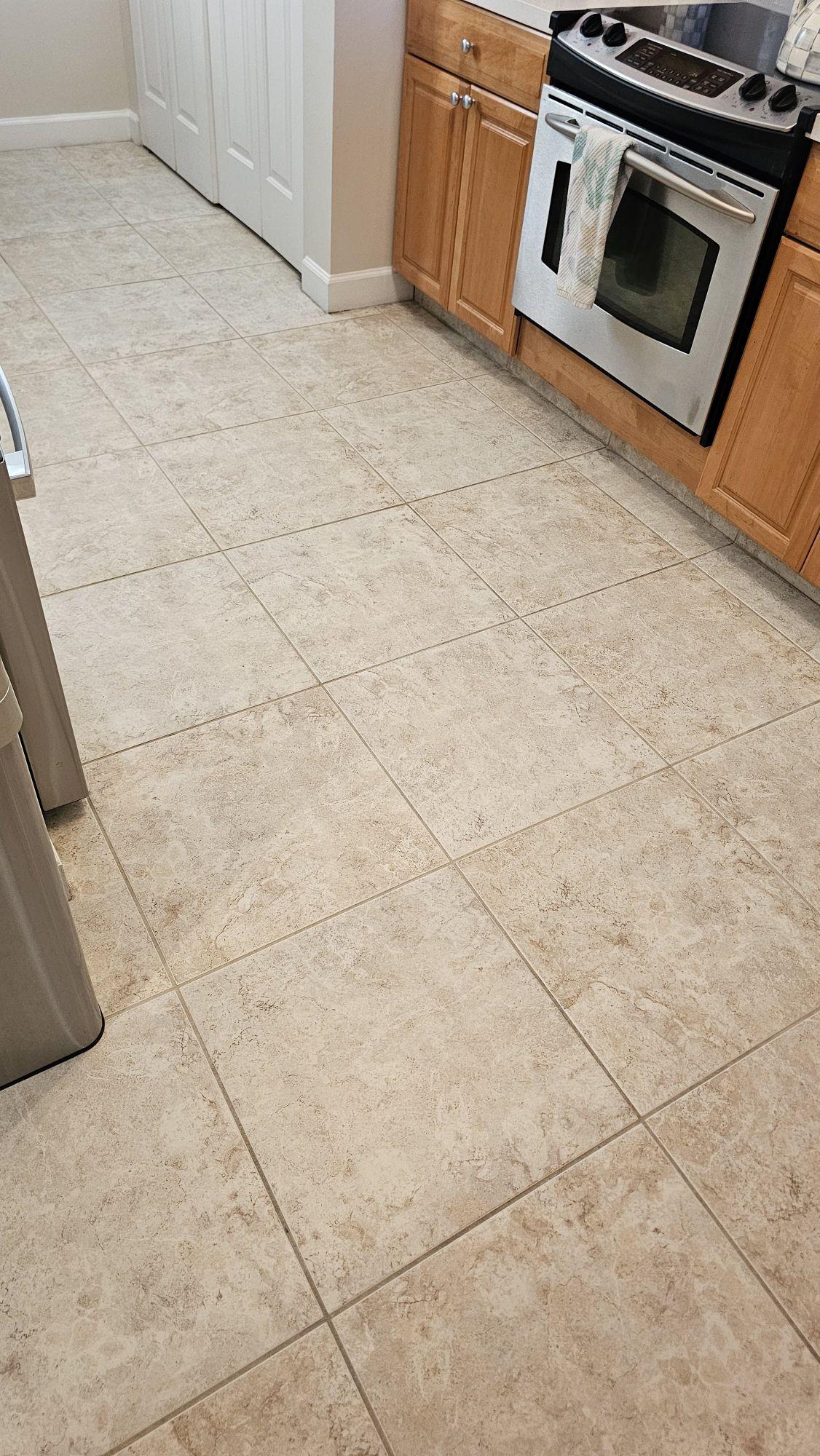 Beige stone-look ceramic tile in an Islamorada condo kitchen after tile and grout cleaning