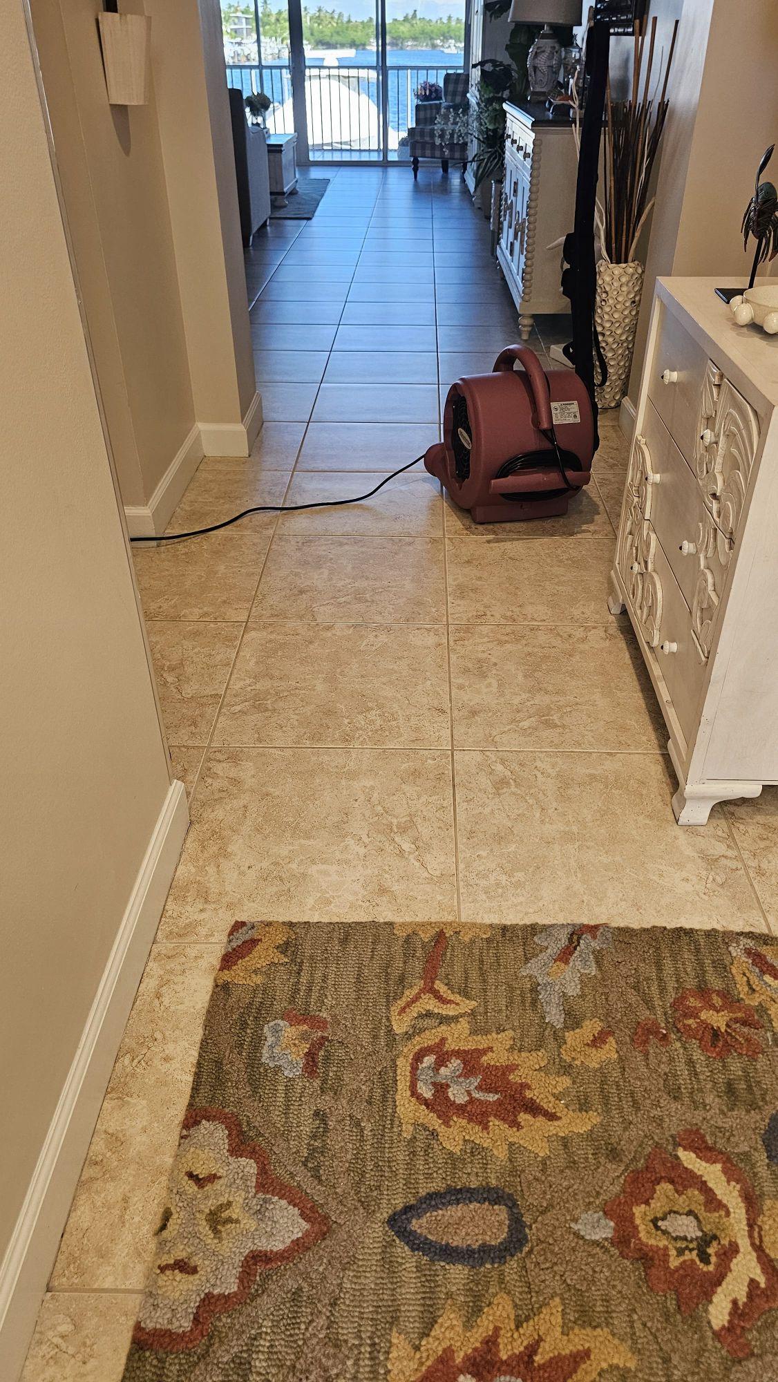 Hallway ceramic tile in an Islamorada condo, cleaned along the traffic path with an air mover drying the floor