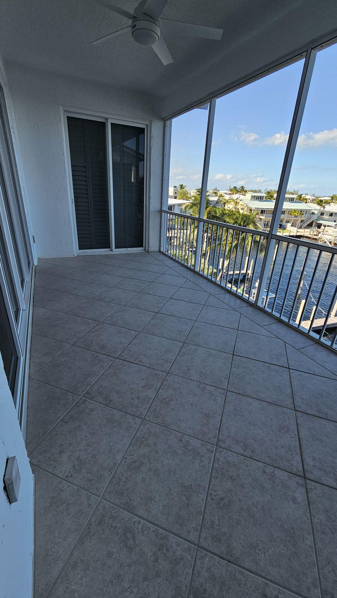 Screened balcony ceramic tile with a water view in Islamorada, Florida Keys, after cleaning