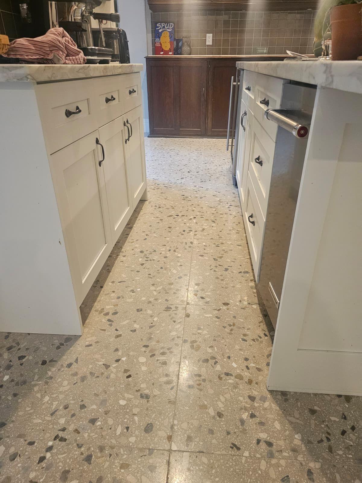The same terrazzo along the kitchen island after grout fill, polish and seal