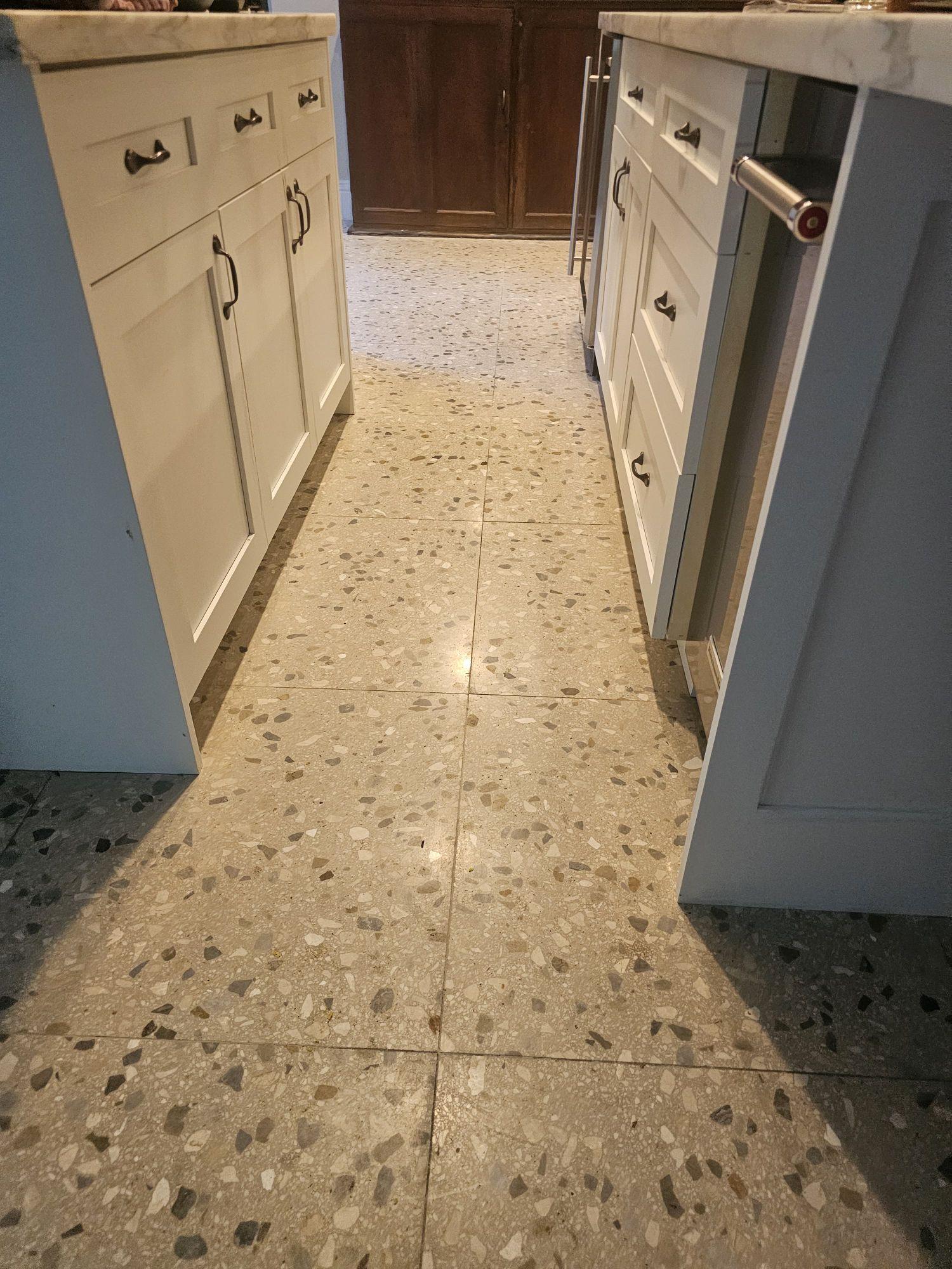 Open grout joints along a kitchen island on Coconut Grove terrazzo, before