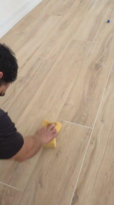 Wiping down wood-look tile during grout color sealing in Pinecrest