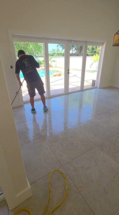 Crew working on porcelain tile near the patio doors in a Miami Lakes home