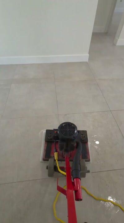 Cleaning machine on large-format porcelain tile in an empty Miami Lakes home