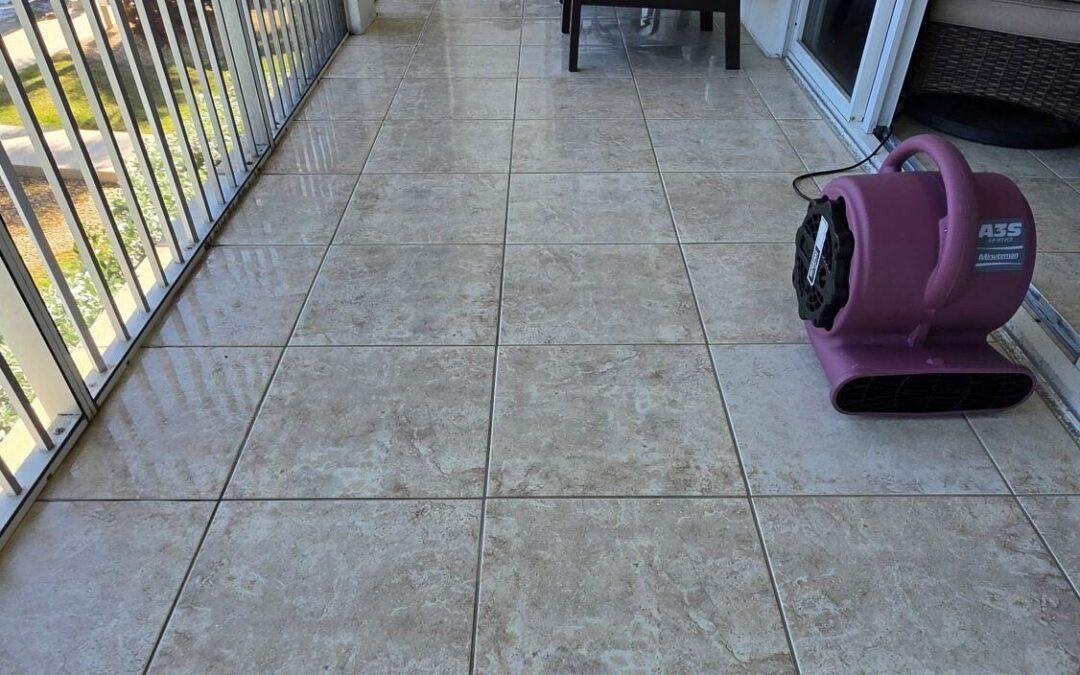Ceramic tile on a screened balcony in an Islamorada condo, with an air mover drying the floor after cleaning