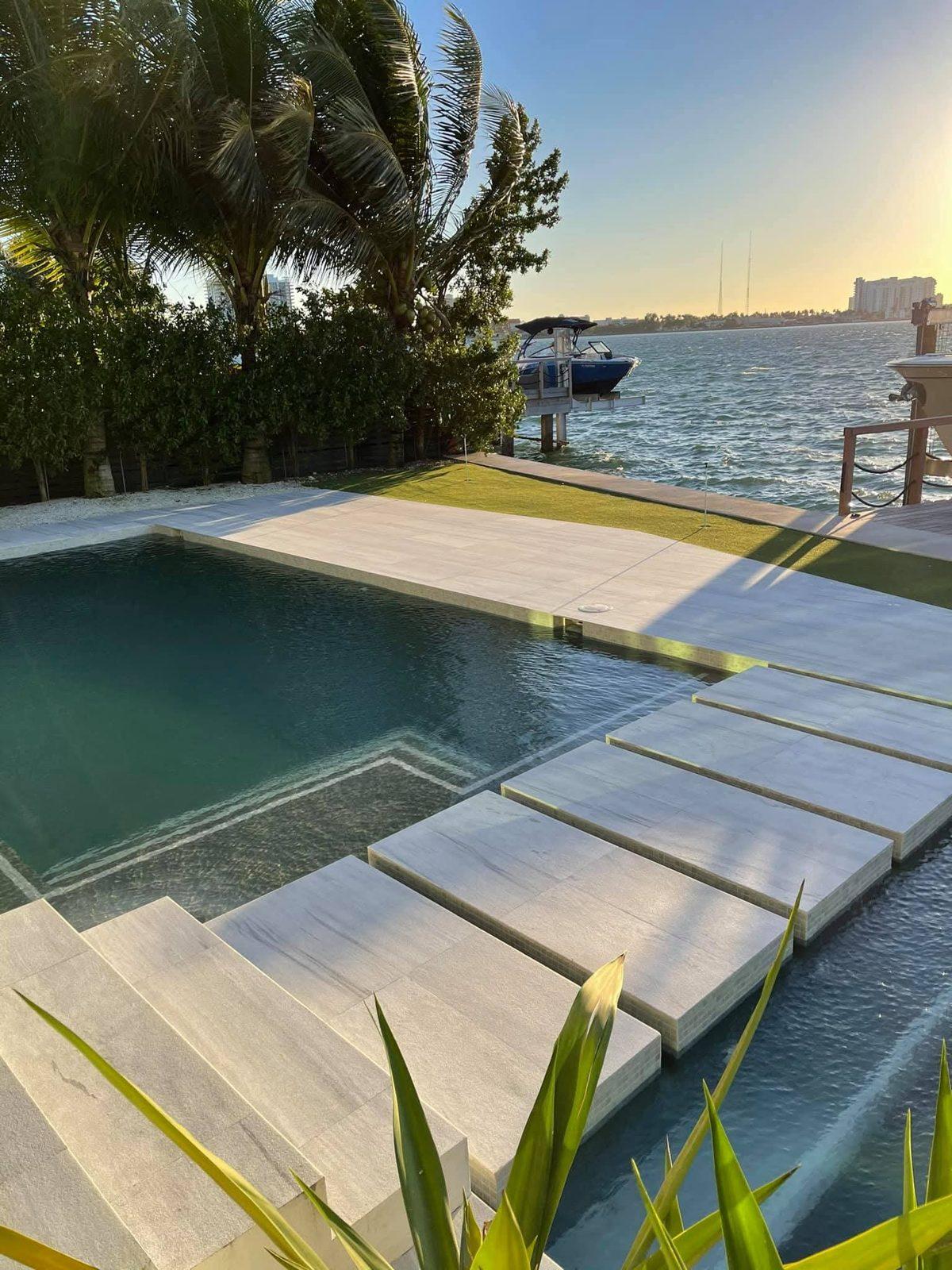 Stone sealing in Miami on a natural stone pool deck and stepping stones at a waterfront home